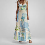 Woman wearing a long, patterned dress with a neutral background