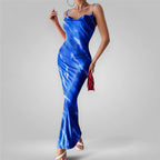Woman wearing a blue tie-dye dress on a gray background